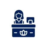 Icon of a receptionist at a front desk with a computer.