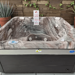 Outdoor hot tub with surrounding plants.